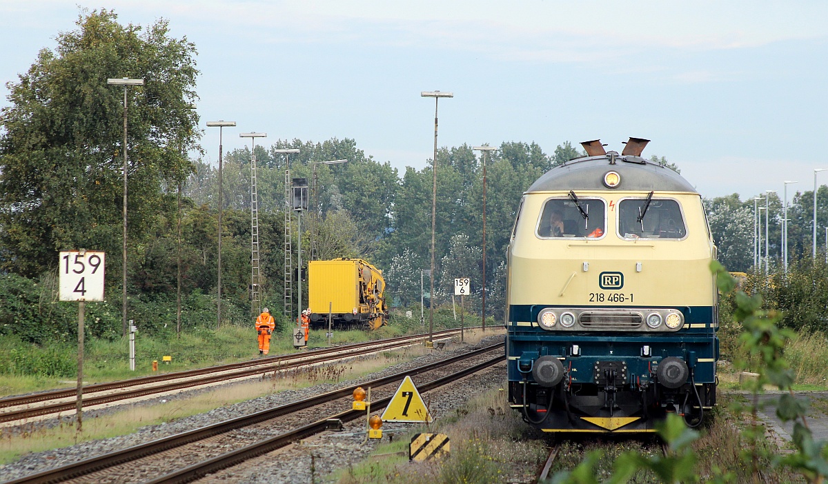 Über den Zaun geschaut...RPRS 218 466-1 steht hier mit ihrem Bauzug im Zufahrtgleis zur Abstellung Husum-Nord. 10.10.2021